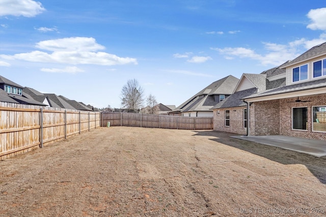 view of yard with a fenced backyard and a patio