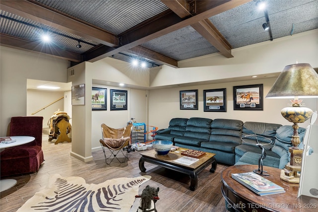 living room featuring wood-type flooring, track lighting, and beamed ceiling