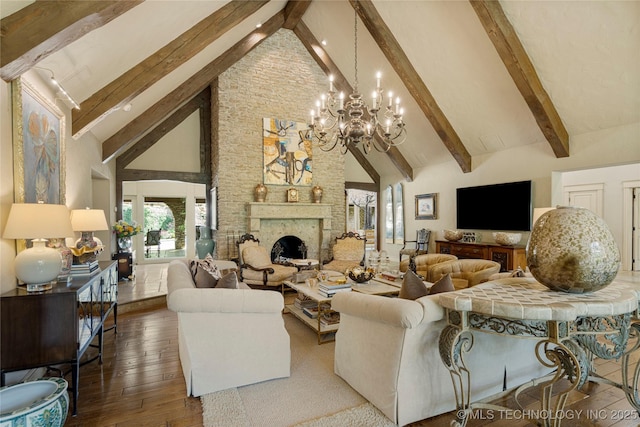 living room featuring dark hardwood / wood-style flooring, beamed ceiling, a stone fireplace, a chandelier, and high vaulted ceiling