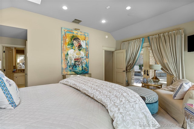 bedroom featuring ensuite bathroom and lofted ceiling