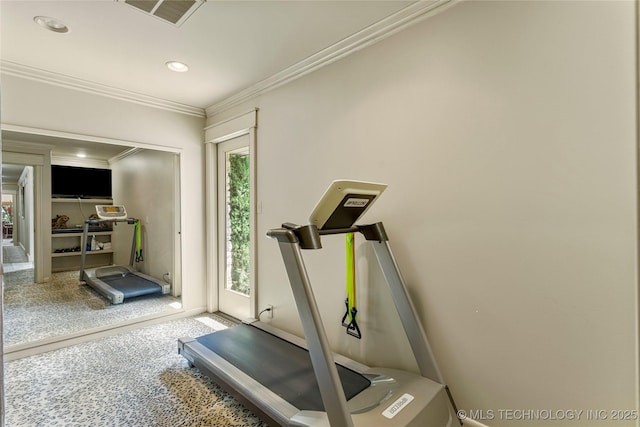 exercise room featuring crown molding