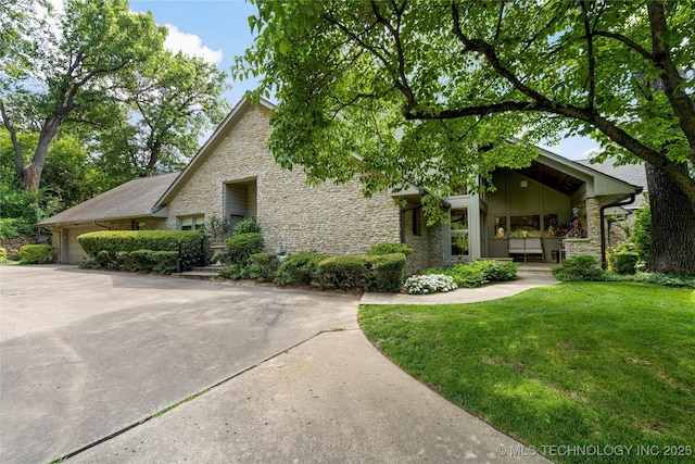 view of front of property featuring a garage and a front yard