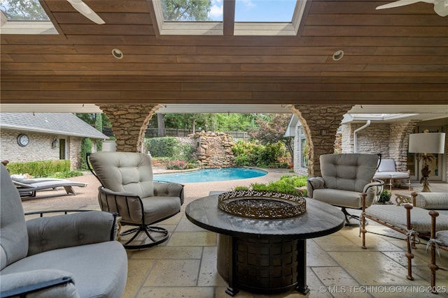 view of patio featuring ceiling fan, outdoor lounge area, and a fenced in pool