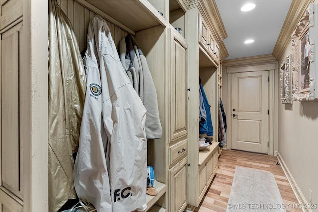 mudroom with crown molding and light hardwood / wood-style floors