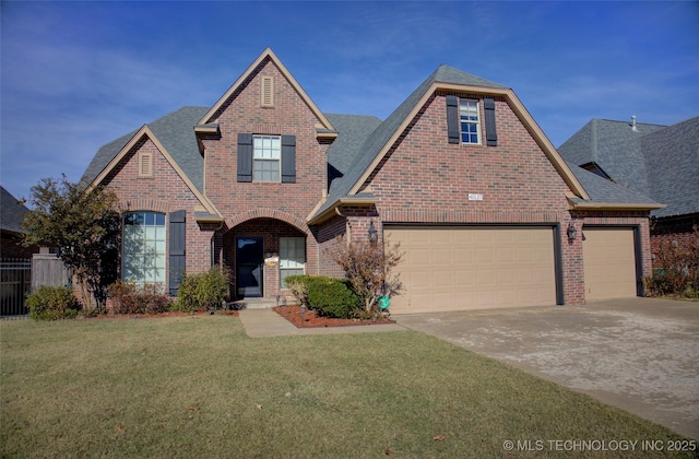 view of property featuring a front yard and a garage