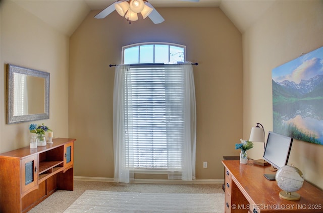 carpeted home office featuring vaulted ceiling, ceiling fan, and a wealth of natural light