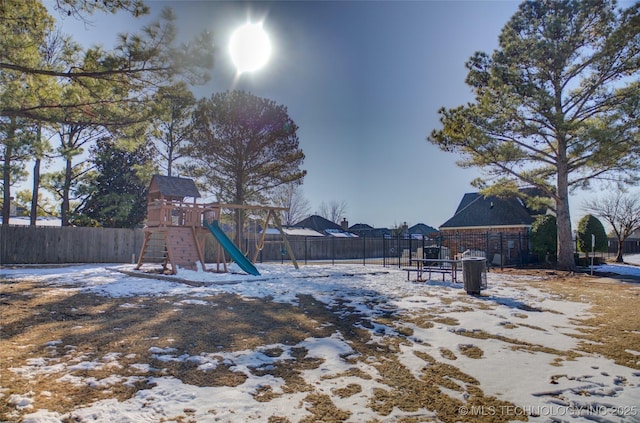 snowy yard with a playground