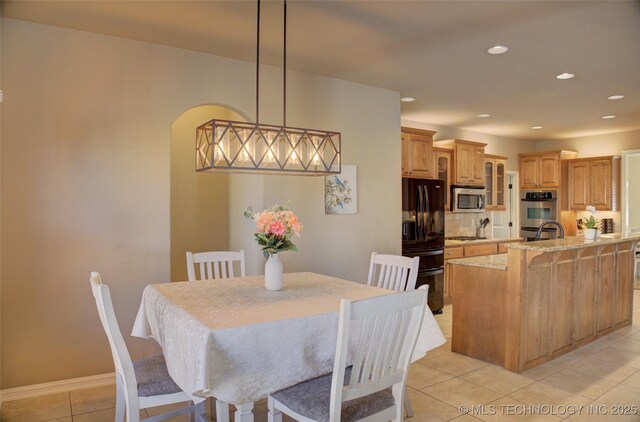 dining area with sink and light tile patterned floors