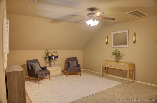 sitting room featuring ceiling fan, carpet floors, and vaulted ceiling