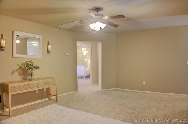 unfurnished room featuring ceiling fan and light colored carpet