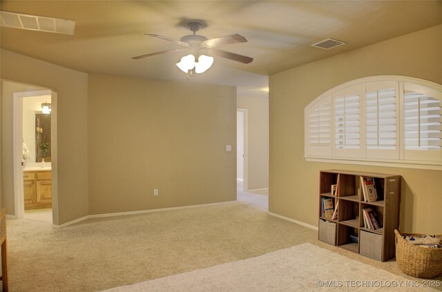 unfurnished room featuring ceiling fan and light colored carpet