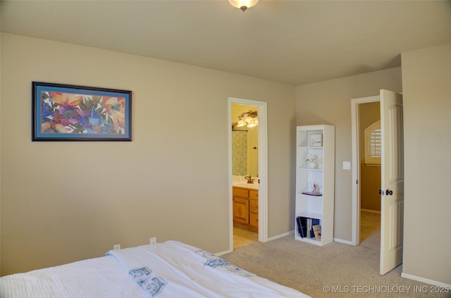 bedroom featuring light carpet and ensuite bath