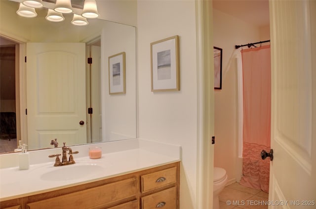 full bathroom with shower / bath combo with shower curtain, toilet, vanity, and tile patterned flooring