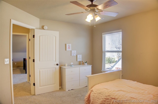 bedroom featuring ceiling fan, light colored carpet, and multiple windows