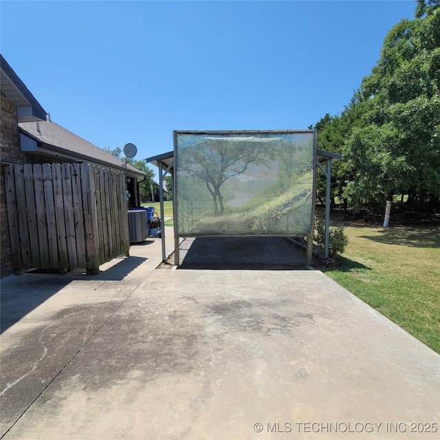 view of gate with central air condition unit and a lawn