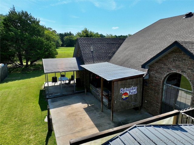 view of side of property featuring a yard and a carport