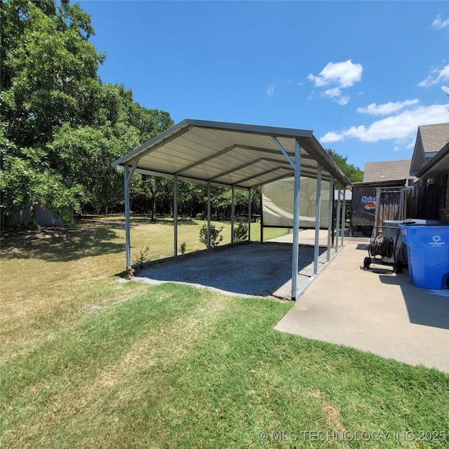 view of parking / parking lot with a yard and a carport