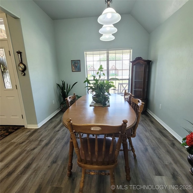 dining area with lofted ceiling and dark hardwood / wood-style flooring