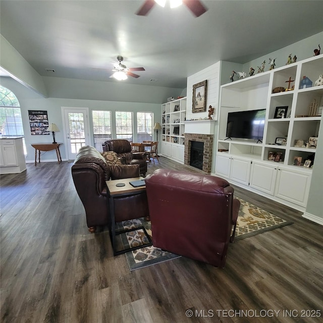 living room with ceiling fan, dark hardwood / wood-style floors, and a fireplace