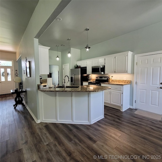 kitchen featuring pendant lighting, kitchen peninsula, sink, appliances with stainless steel finishes, and white cabinets