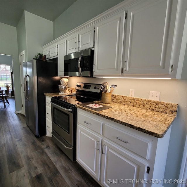 kitchen with dark wood-type flooring, stainless steel appliances, white cabinets, and light stone countertops