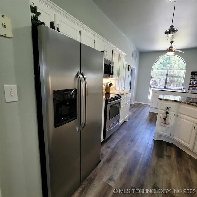 kitchen with white cabinets, appliances with stainless steel finishes, decorative light fixtures, dark hardwood / wood-style floors, and ceiling fan