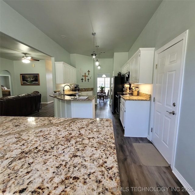 kitchen featuring ceiling fan, white cabinetry, dark hardwood / wood-style floors, and hanging light fixtures