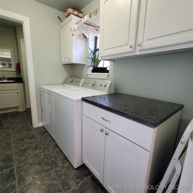 laundry area with cabinets, separate washer and dryer, and sink