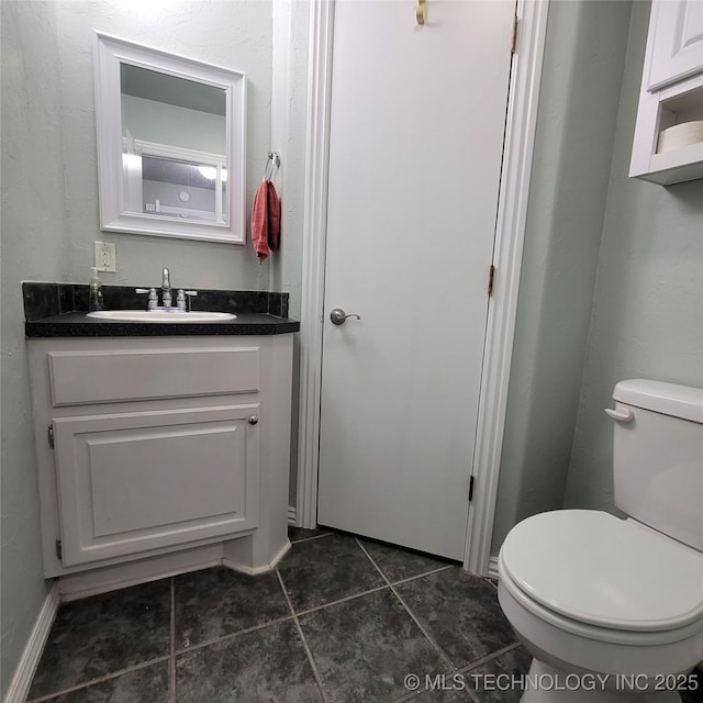 bathroom featuring toilet and vanity