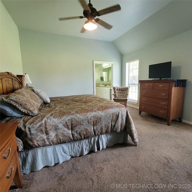 bedroom with ceiling fan, light colored carpet, ensuite bath, and vaulted ceiling