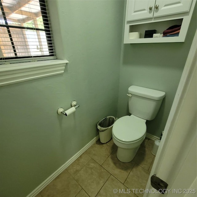 bathroom with toilet and tile patterned floors