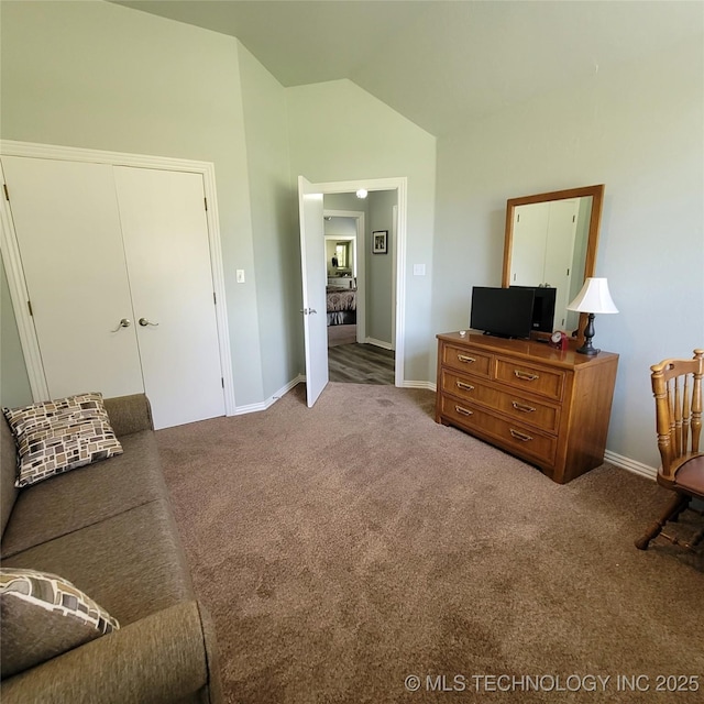 sitting room with carpet floors and lofted ceiling