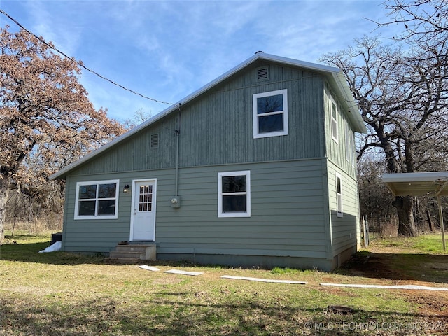 back of house with a yard