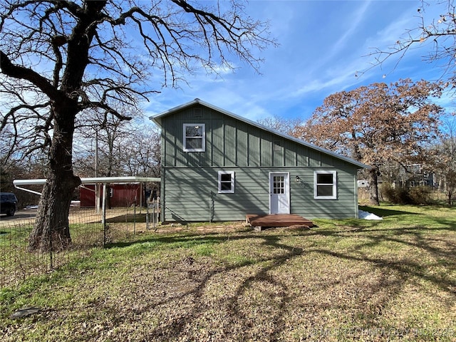 rear view of property featuring a lawn