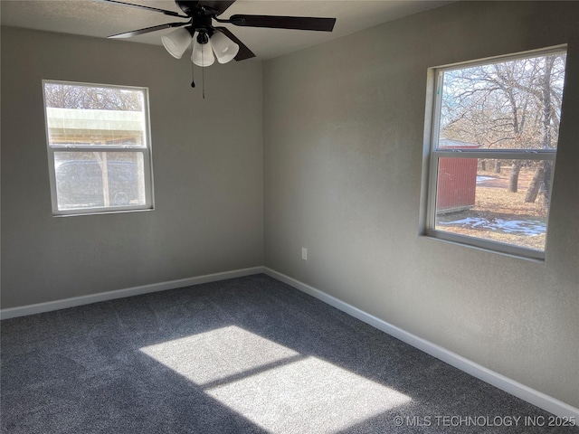 carpeted spare room with ceiling fan