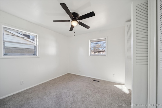 spare room featuring ceiling fan and carpet flooring