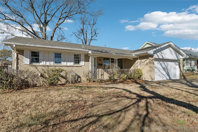 ranch-style home featuring a garage and a front lawn