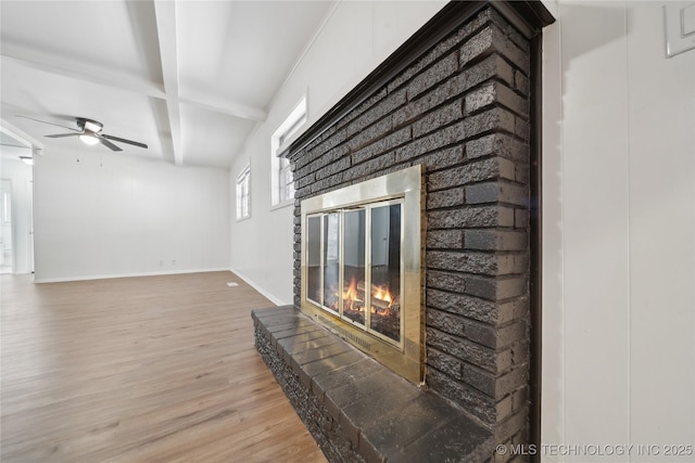 unfurnished living room featuring ceiling fan, a fireplace, light hardwood / wood-style floors, beamed ceiling, and coffered ceiling