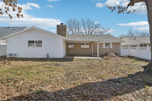 back of property featuring a patio area and a yard