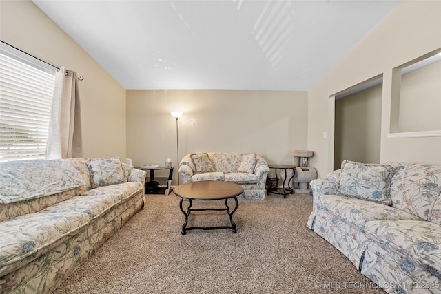 carpeted living room with lofted ceiling