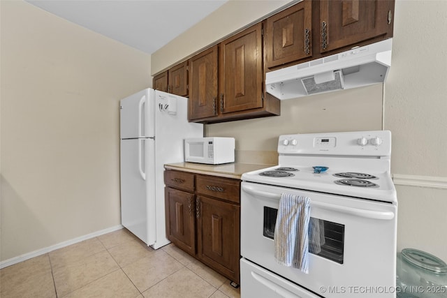 kitchen with light tile patterned floors, dark brown cabinetry, and white appliances