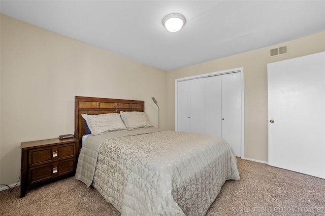 bedroom with light carpet and a closet