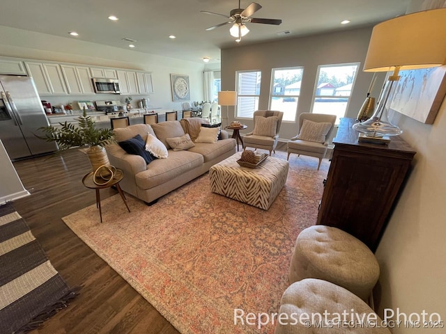 living room featuring ceiling fan and dark wood-type flooring