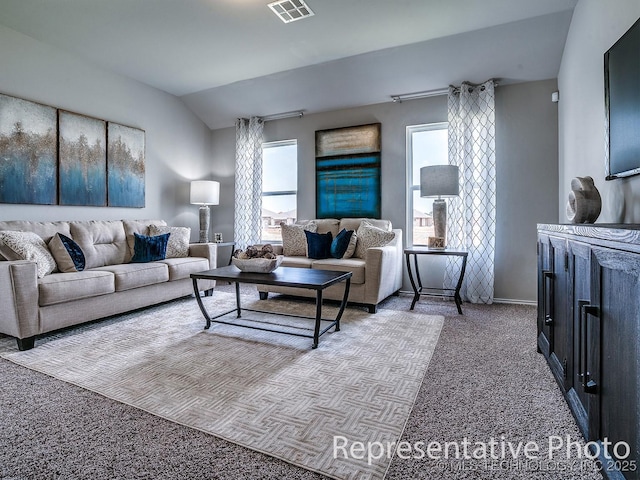 carpeted living room featuring lofted ceiling and a healthy amount of sunlight