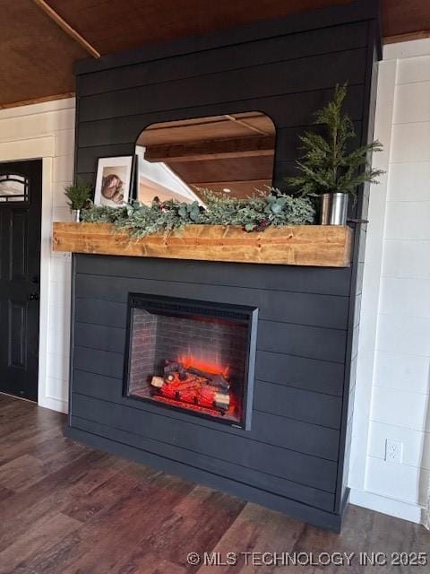 room details with hardwood / wood-style floors and wood walls