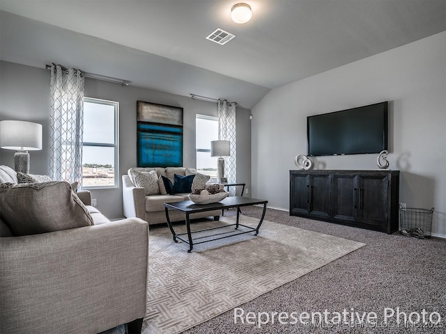 carpeted living room featuring lofted ceiling