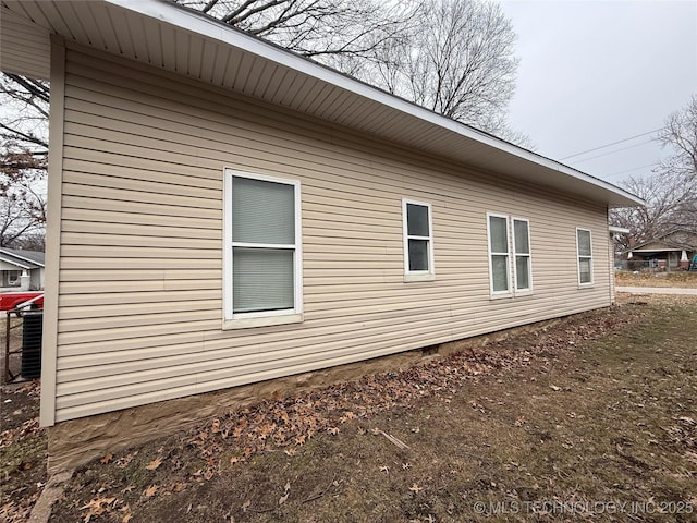 view of side of property with central air condition unit