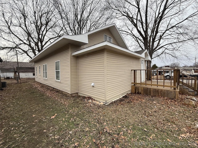 view of property exterior featuring a wooden deck and central air condition unit