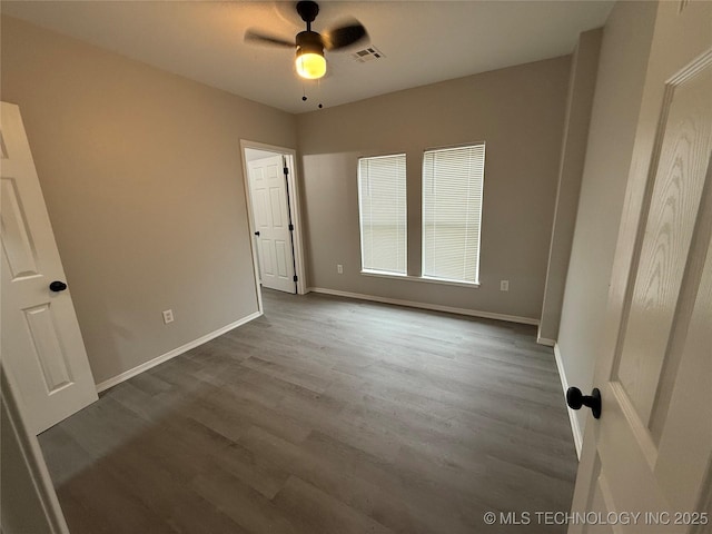 unfurnished bedroom with ceiling fan and wood-type flooring