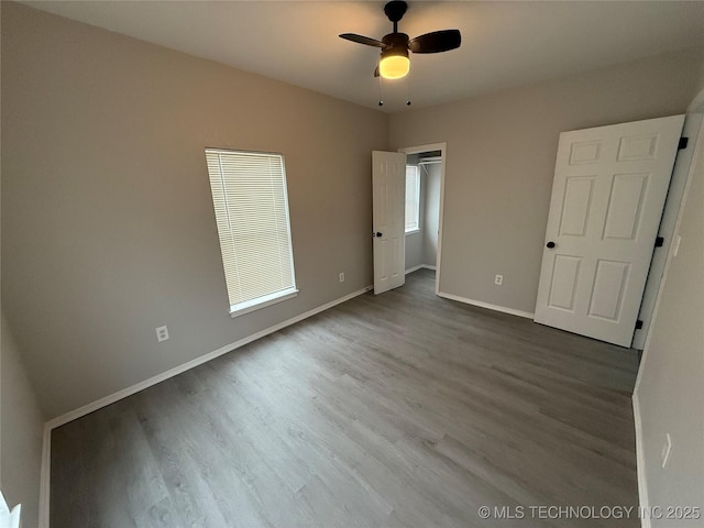 unfurnished bedroom with ceiling fan and wood-type flooring